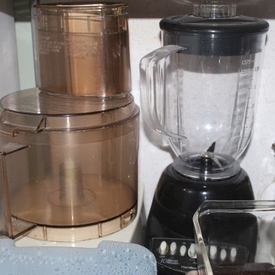 Sale Photo Thumbnail #74: Countertop food processor with tinted plastic work bowl alongside a black Hamilton Beach BlendMaster 10-speed blender.