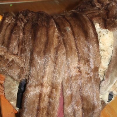 Sale Photo Thumbnail #97: Vintage dark brown mink fur coat draped over a chair, featuring vertical pelt striping.