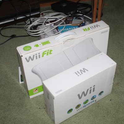 Sale Photo Thumbnail #67: Nintendo Wii console box with Wii Sports and a Nintendo Wii Fit balance board box, circa late 2000s.