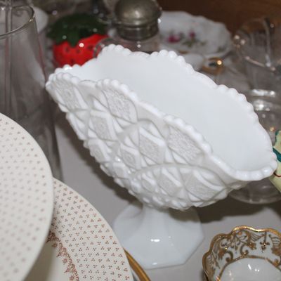 Sale Photo Thumbnail #30: Vintage white milk glass pedestal dish featuring a diamond geometric pattern and scalloped rim, surrounded by various glassware and porcelain collectibles.