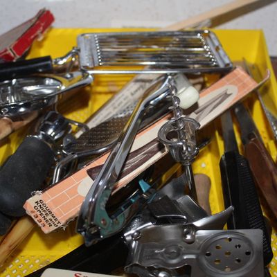 Sale Photo Thumbnail #76: Assorted vintage kitchen gadgets and hand tools resting in a yellow plastic organizer tray.