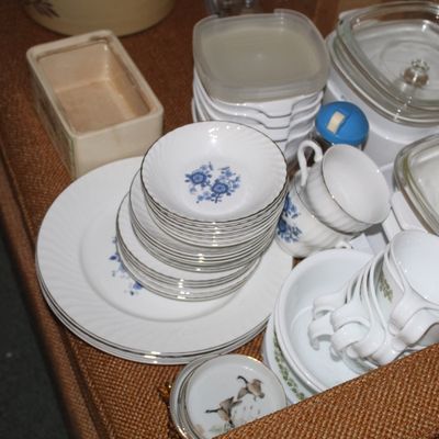 Sale Photo Thumbnail #23: Assortment of vintage dishware, including floral-patterned ceramic plates, small bowls, teacups, and CorningWare style glass-lidded casserole dishes.