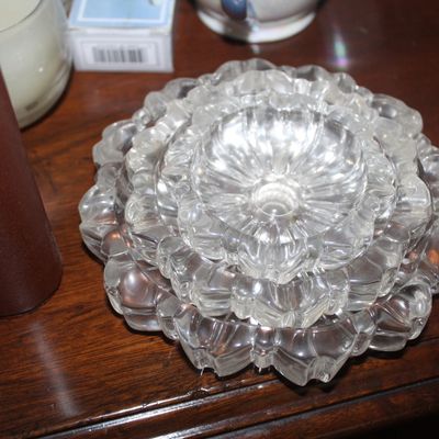 Sale Photo Thumbnail #47: Set of three vintage clear glass nesting ashtrays featuring scalloped lotus petal rims.