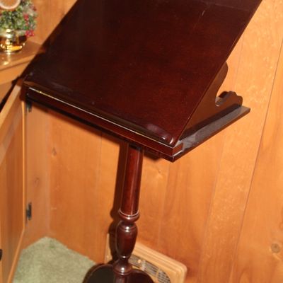 Sale Photo Thumbnail #69: Traditional mahogany lectern or music stand featuring an angled book rest, turned pedestal column, and tripod cabriole legs.