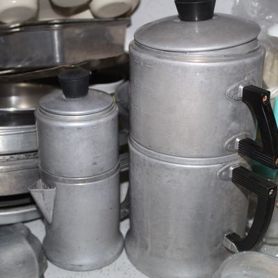 Sale Photo Thumbnail #75: Vintage aluminum drip coffee pots with black Bakelite handles, surrounded by various vintage kitchenware and bakeware.