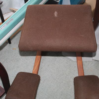 Sale Photo Thumbnail #33: Ergonomic wooden kneeling chair with brown fabric upholstered cushions.