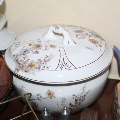 Sale Photo Thumbnail #49: Antique porcelain covered tureen with delicate floral transferware motifs and gold trim accenting the lid handle.