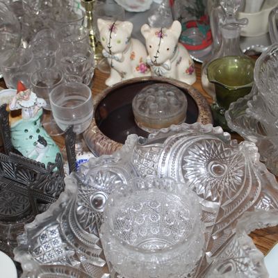 Sale Photo Thumbnail #22: Collection of vintage glassware and knick-knacks, including cut glass bowls, stemware, decanters, ceramic cat figurines, and decorative trinket boxes.