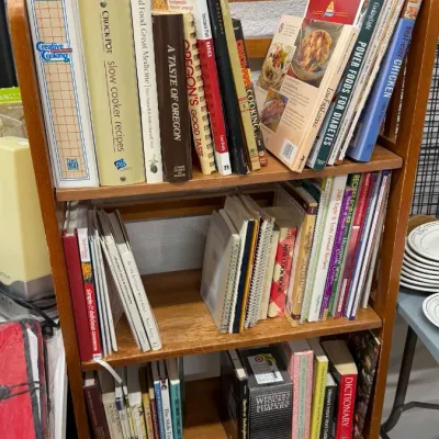 Cookbooks, regional recipe guides, and reference dictionaries displayed on shelves.