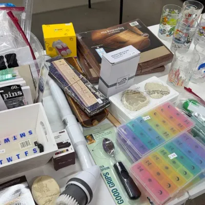 Selection of household items including various pill organizers, vintage character drinking glasses, stationery supplies, expanding files,...