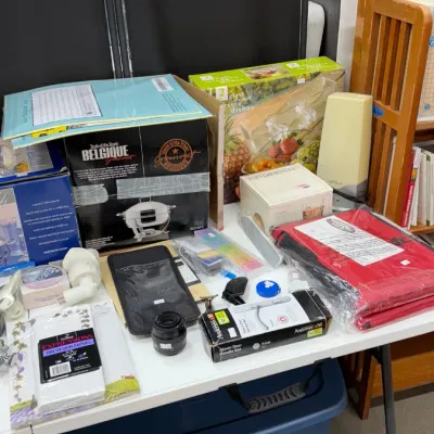Household goods, cookware in boxes, stationery supplies, small electronics, and an Andersen storm door handle set.