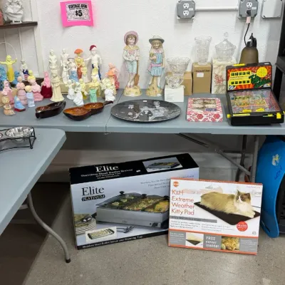 Assorted household goods including vintage Avon perfume bottles, figurines, glassware, an Elite buffet server in box, and a K&H...