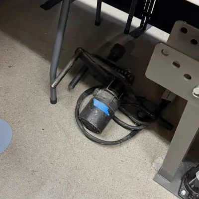 Heavy-duty electric motor with power cord and attached metal frame assembly.