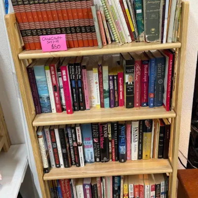 A 15-volume Childcraft book set, various hardcover fiction and non-fiction titles, reference books, and paperbacks.
