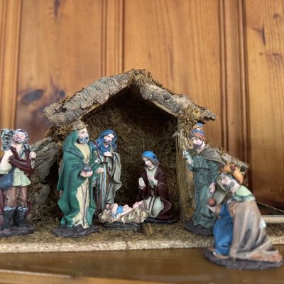Sale Photo Thumbnail #5: Vintage Nativity scene featuring painted resin figurines and a bark-covered wooden creche structure.