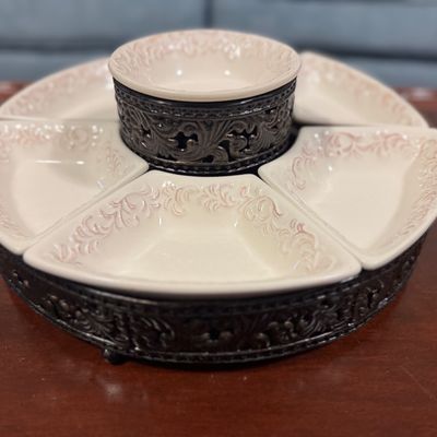 Sale Photo Thumbnail #21: Ceramic and metal chip-and-dip lazy Susan serving set featuring five wedge-shaped dishes and a central raised bowl in an ornate scrollwork metal stand.