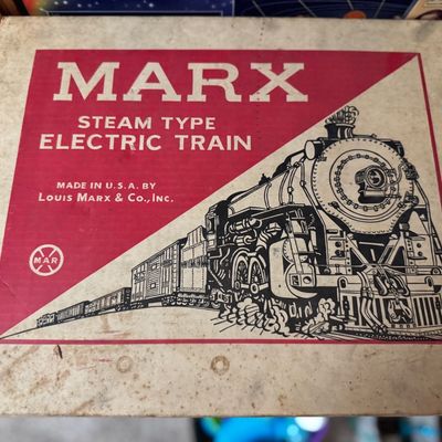 Sale Photo Thumbnail #10: Vintage Marx Steam Type Electric Train box, featuring classic red and white graphics by Louis Marx & Co., Inc. The cardboard packaging shows light wear consistent with age.