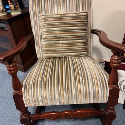 Sale Photo Thumbnail #29: Vintage wooden rocking chair upholstered in a multi-color striped fabric, complete with a matching accent pillow.