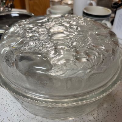 Sale Photo Thumbnail #17: Vintage clear pressed glass covered casserole dish featuring an embossed fruit pattern on the lid.