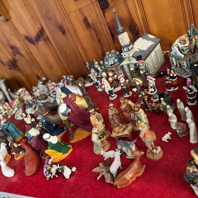 Sale Photo Thumbnail #8: Large collection of Christmas decorations, including detailed nativity scene figurines, miniature winter village buildings, and carolers.