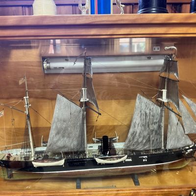 Sale Photo Thumbnail #11: Detailed scale model of a 19th-century Civil War steam and sail warship housed inside a wooden display case.