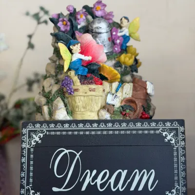 Sale Photo Thumbnail #39: Whimsical garden fairy figurine mounted on a wooden base inscribed with the word "Dream".