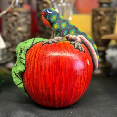 Sale Photo Thumbnail #59: Huichol beaded art figurine featuring a colorful beaded lizard wrapped around a painted wooden apple.