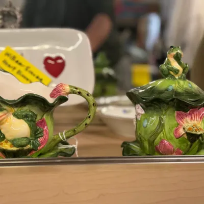 Sale Photo Thumbnail #76: Whimsical ceramic frog and water lily creamer and lidded sugar bowl set featuring embossed frog accents and lily pad motifs.
