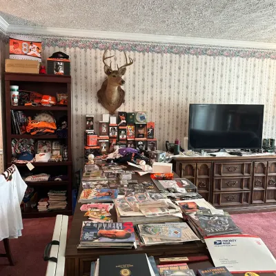 Collection of sports memorabilia, including Baltimore Orioles collectibles, trading cards, magazines, and bobbleheads, alongside a...