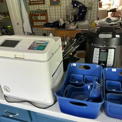 Selection of kitchen appliances featuring a Zojirushi bread maker, a Power Quick Pot multi-cooker, and blue ceramic baking containers.