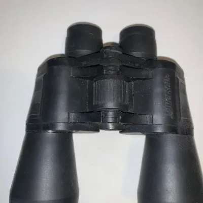 Ingersoll black rubber-armored binoculars featuring a center focus wheel.