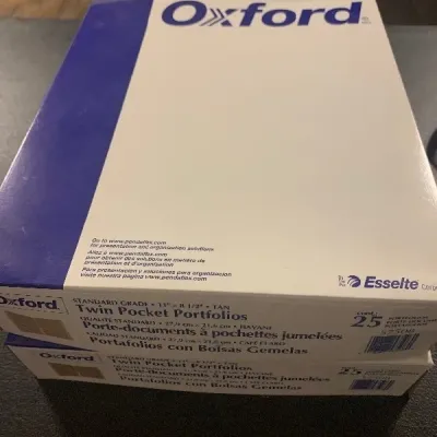 Two 25-count boxes of Oxford standard grade tan twin pocket portfolios.