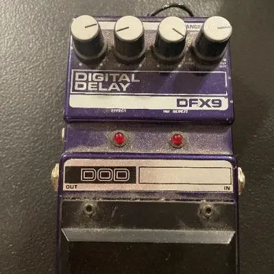 Vintage DOD DFX9 Digital Delay guitar effects pedal in purple housing with four control knobs. Shows light dust and wear consistent with...