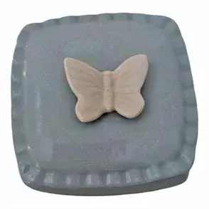 Square light blue glazed ceramic trinket box featuring a cream-colored butterfly motif on the lid.