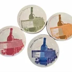 Set of four wine-themed porcelain appetizer plates featuring illustrations of wine bottles, grapes, and wine-pairing charts.