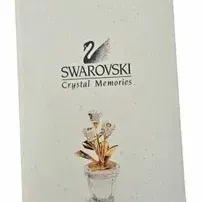 Swarovski Crystal Memories Classics booklet, featuring the brand logo and an illustration of a potted crystal flower figurine.