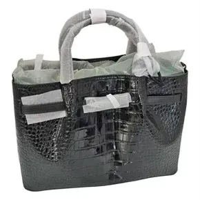 Black crocodile-embossed leather tote bag, new with protective foam wrappings on handles and hardware.