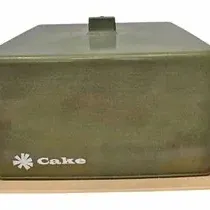 Vintage avocado green plastic square cake carrier with beige base, labeled "Cake" in classic retro typography.