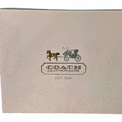 Coach Leatherware gift or product box featuring the classic horse and carriage logo.