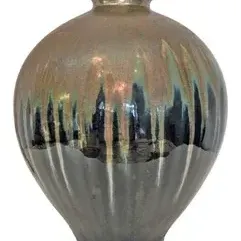Studio pottery ceramic vase with a metallic drip glaze finish over a ribbed lower body.