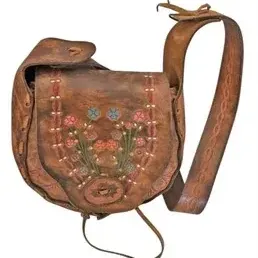 Vintage handmade leather shoulder bag featuring embroidered floral motifs on the front flap and a tooled leather strap.