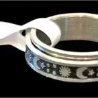Silver-tone celestial spinner ring featuring a sun, moon, and star pattern, complete with an attached retail tag.