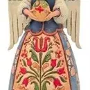 Jim Shore Heartwood Creek folk art angel figurine featuring intricate carved-style floral and quilt patterns.