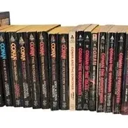 Collection of vintage Conan the Barbarian paperback books in worn, read condition.