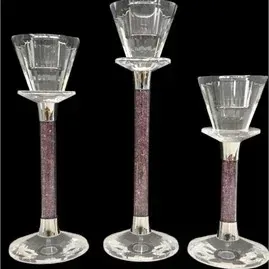 Set of three graduated contemporary glass candle holders featuring purple crushed crystal accents inside the stems.