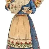 Jim Shore Heartwood Creek angel figurine holding a teapot and teacup, featuring folk art patterns and carved wood-look details.