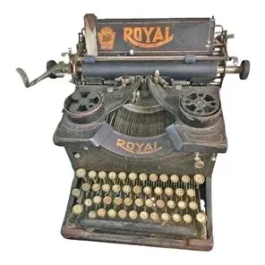 Antique Royal Model 10 desktop manual typewriter featuring glass-bezeled keys and exposed mechanism, showing vintage wear and patina.
