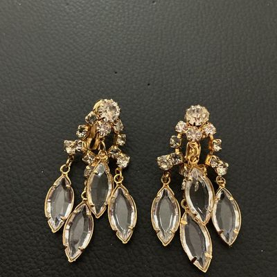 Sale Photo Thumbnail #241: Pair of vintage gold-tone clip-on dangle earrings set with clear round rhinestones and navette/marquise-cut glass stones in dangling drops. Each earring measures approximately 2 inches (50 mm) in length. Shows minor vintage surface wear; all stones are in