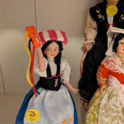 Collection of vintage Eros souvenir dolls in traditional Italian regional costumes, including a Napoli figure with tambourine and ribbon...