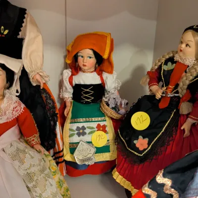 Collection of vintage European souvenir dolls in detailed regional folk costumes, including an Italian Magis Roma doll carrying a flower...